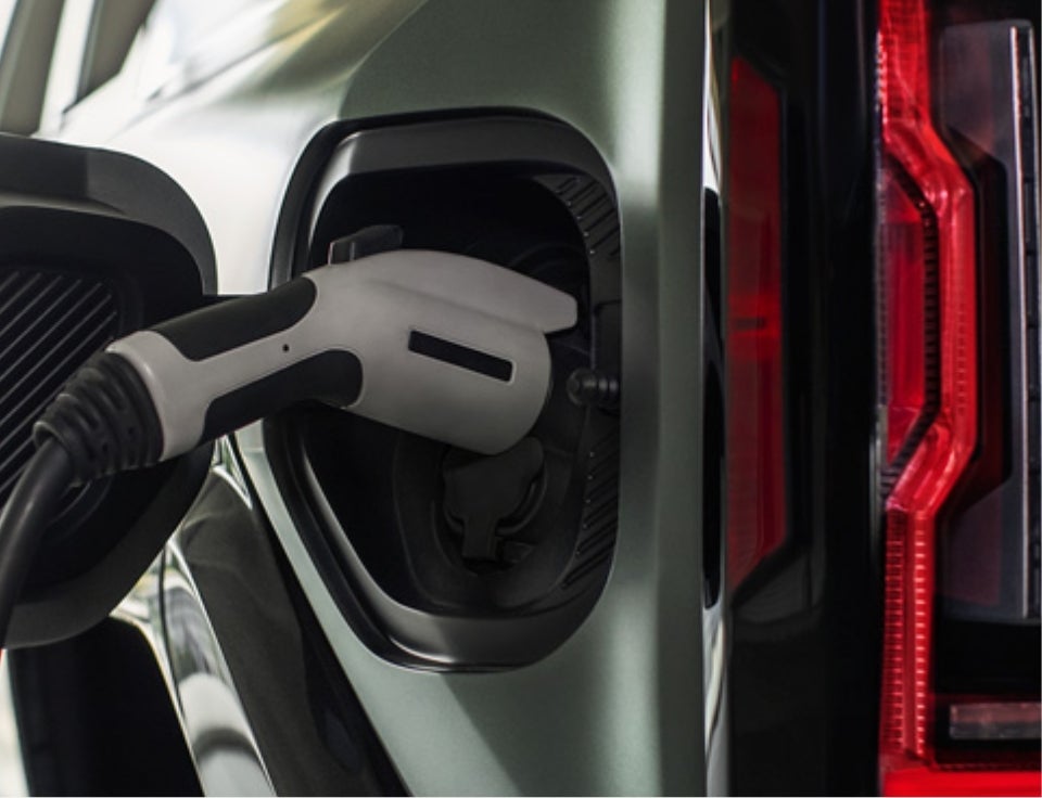 Close up of charging port with charger plugged in on a GMC Hummer EV SUV - Larkin Cobb GMC in Eaton OH