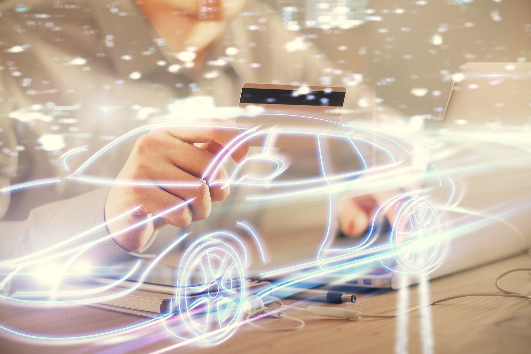 animated photo of a car made out of light with a person in the background holding a credit card
